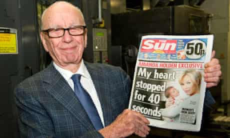 Rupert Murdoch with the first issue of the Sun on Sunday