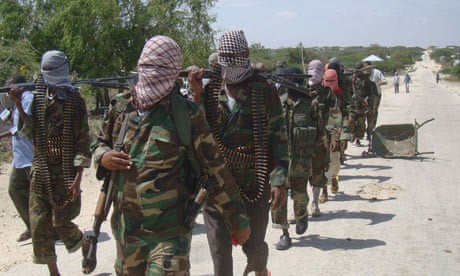 Al-Shabab fighters walk through Mogadishu