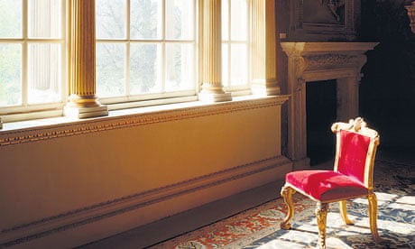 Velvet chair in front of a big window in a grand house