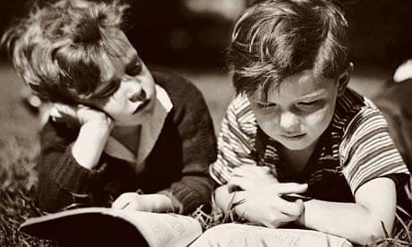 1950s photo of two boys reading outdoors