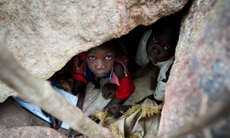 Nuba children take cover in caves
