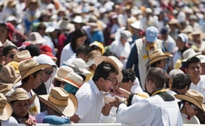 Pope visit to Mexico: A man receives communion during an open-air mass