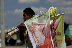 Pope visit to Mexico: A vendor sells flags with the image of Pope Benedict XVI on a road