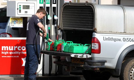 A man fills up jerry cans in a panic at a petrol station in Linlithgow