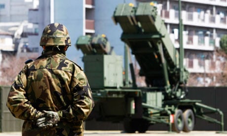 JSDF soldier near Patriot Advanced Capability-3 (PAC-3) missiles at the Defence Ministry in Tokyo