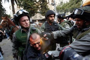 Land Day protests: Israeli police officers use pepper spray an injured Palestinian protester