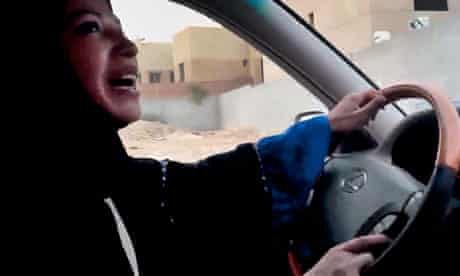 A Saudi Arabian woman drives a car as part of a campaign to defy the ban on women driving
