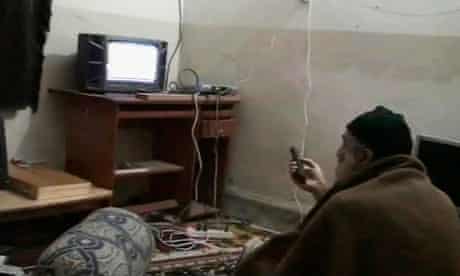 Osama bin Laden is shown watching himself on television