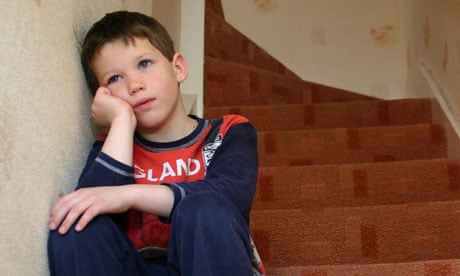 Unhappy boy sitting on stairs