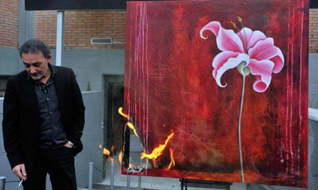 Antonio Manfredi, director of CAM of Casoria, burns a painting of French artist Severine Bourguignon