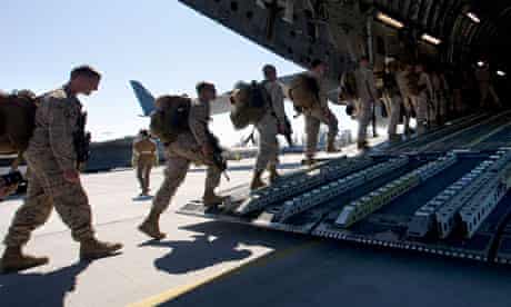 US marines board a military transport plane to be taken to Afghanistan. 