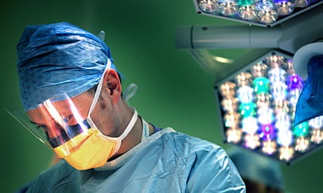 A surgeon performs an operation