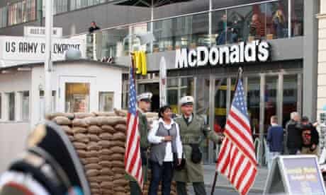US 'soldiers' pose with tourists for pictures at Checkpoint Charlie