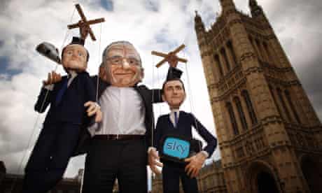 'Rupert Murdoch' holds up puppets of David Cameron and Jeremy Hunt