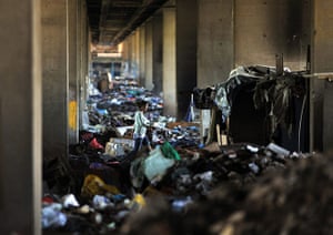 24 hours: Belgrade, Serbia: A Roma woman walks through a garbage filled slum