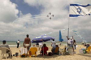 24 hours: Tel Aviv, Israel: People gather on the beach to watch a military show