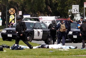 Oakland shooting: An officer walks by what appears to be covered bodies after a shooting 