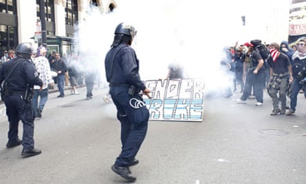 Police officers fire tear gas to control a group of Occupy protesters in downtown Oakland.