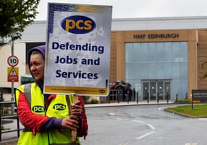 Public Sector strikes: A PCS union member holds a placard the strike action at Saughton prison