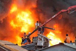 Manila: Residents untie the hose of a cement mixer to douse water on a fire 
