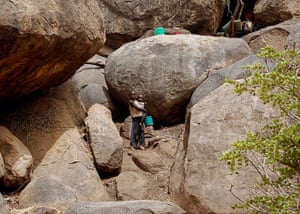 Nuba Mountains Conflict: Children stand outside a cave shelter in Tess village