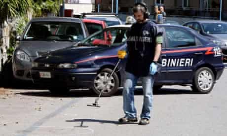 Italian police investigate the site where nuclear engineer Roberto Adinolfi was shot in Genoa. 