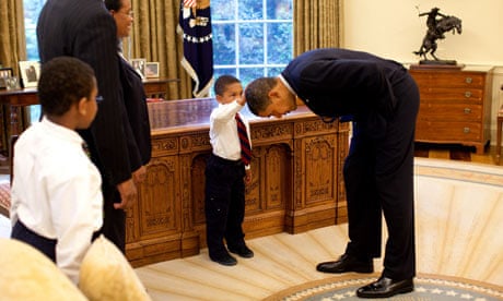 Barack Obama bends over as Jacob Philadelphia pats his head, 2009