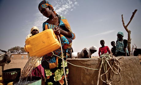 A woman refilling her bucket from a well in Natriguel, in the south of Mauritania