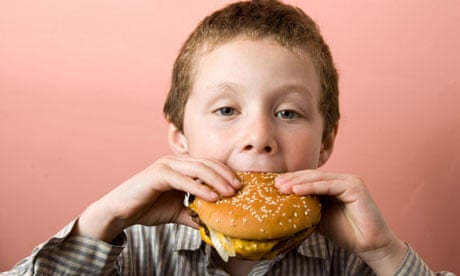 Boy eating McDonald's burger