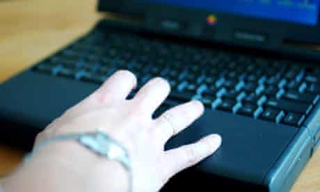 A woman uses a computer keyboard