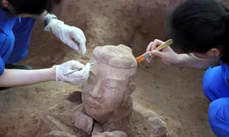 Chinese archaeologists excavate a terracotta warrior 