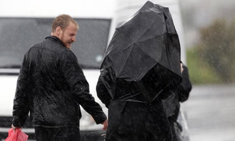 A couple are caught out in the wind and rain in the Welsh town of Porthcawl