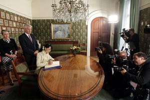Aung San Suu Kyi: Aung San Suu Kyi signs a book at the Nobel Institute