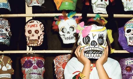 Mexican girl wearing a skull mask for the Day of the Dead