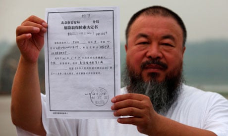 Chinese artist Ai Weiwei holds a copy of