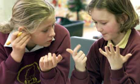 Two schoolgirls count on their fingers