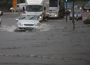 UK Flooding: Penkridge, Staffordshire: Vehicles make their way through a flash flood