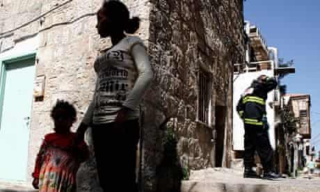Eritreans outside a Jerusalem apartment which was firebombed