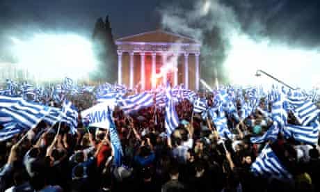 Supporters of the Greek party New Democracy wave flags during a pre-election speech on 3 May