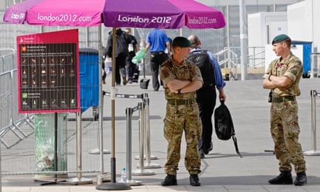 Soldiers guard a security checkpoint at an entrance to the London 2012 Olympic Park in London