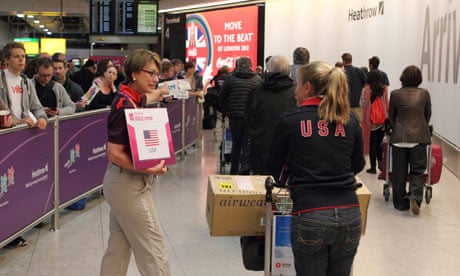 Members of the US Olympic team are met by London 2012 volunteers at Heathrow airport