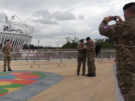 A soldier has his photograph taken in front of the Olympic Stadium in London on 19 July 2012. Photograph: Carl Court/AFP/Getty Images