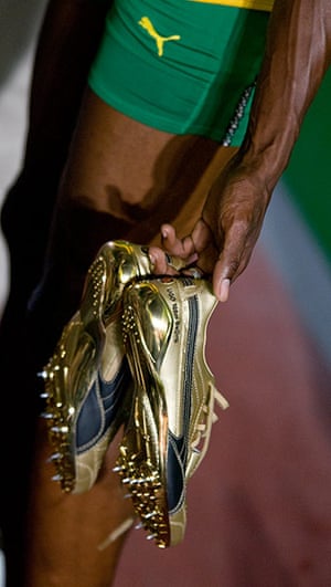 Usain Bolt: Jamaica's Usain Bolt carries his gold running shoes 