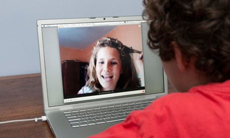 Teenager talking on Skype on Apple laptop computer, England, Britain, UK
