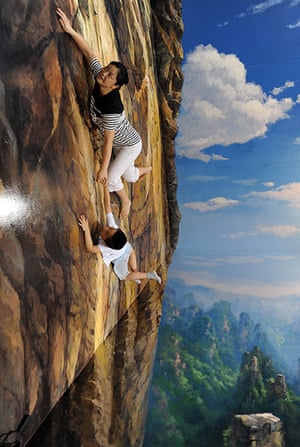 3D art China: People pose with a 3D painting exhibition in Hangzhou