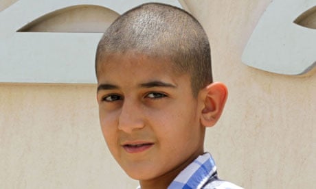 Ali Hasan, 11, leaves a Bahrain police station in June after spending about a month in custody