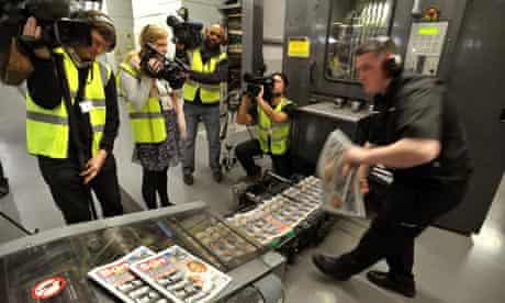 Camera crews film the first copies of the Sun on Sunday rolling off the presses at Broxbourne