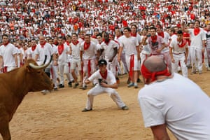 Pamplona: A reveller taunts a fighting cow in the Plaza de Toros