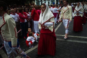 Pamplona: People in traditional dress lead the procession of the statue of San Fermin