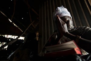 24 hours: APibor, South Sudan: A woman prays at the Presbyterian Church in Sudan